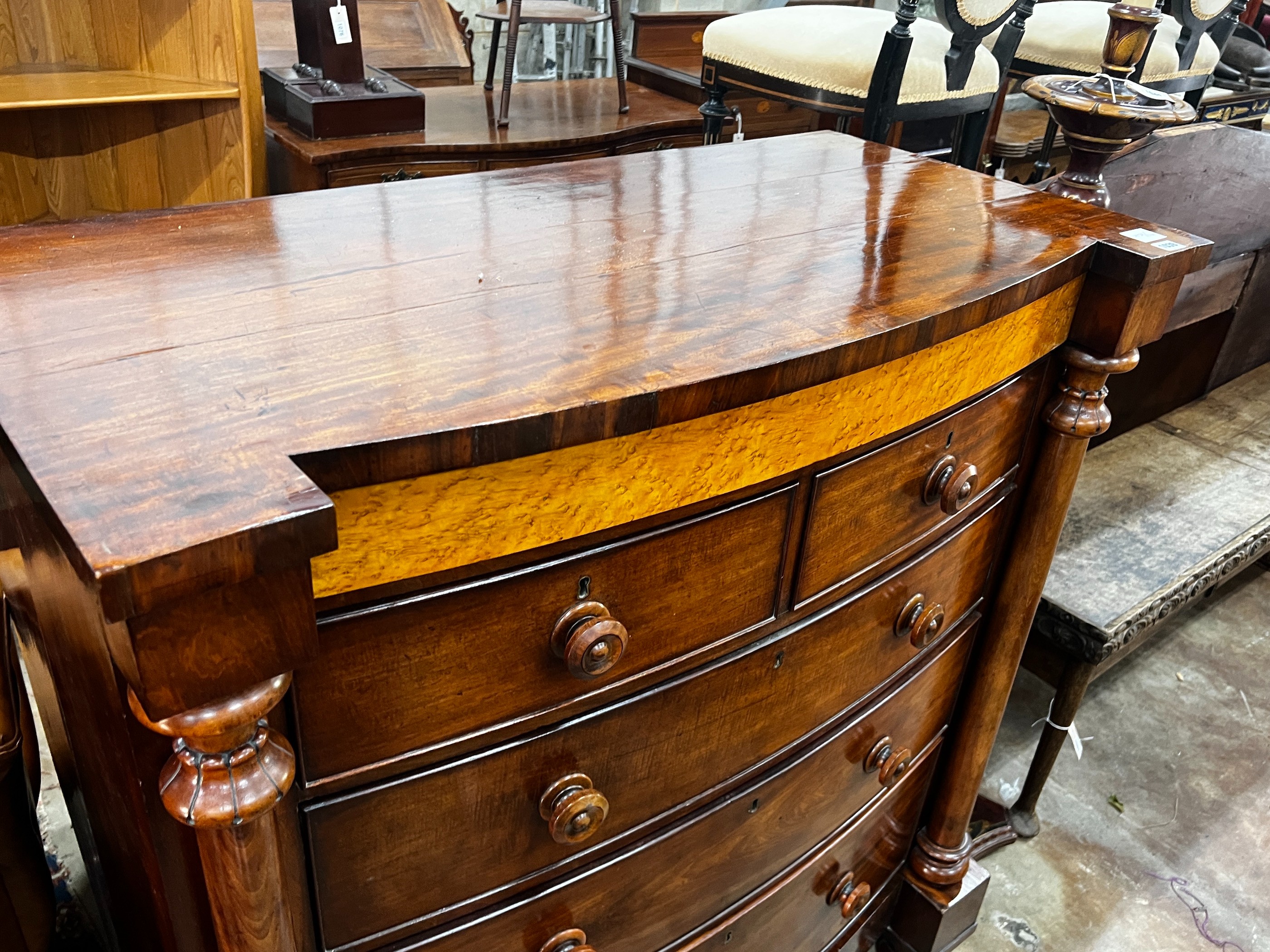 A large mid Victorian mahogany bow front chest of two short and three long drawers, bird's eye maple panel, width 114cm, depth 55cm, height 130cm
